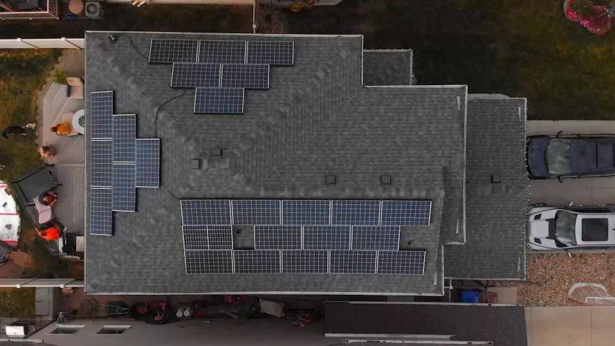 an aerial view of a house with solar panels on the roof